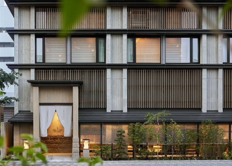 A curtain hangs at the entrance, welcoming guests to Onsen Ryokan Yuen Sapporo.